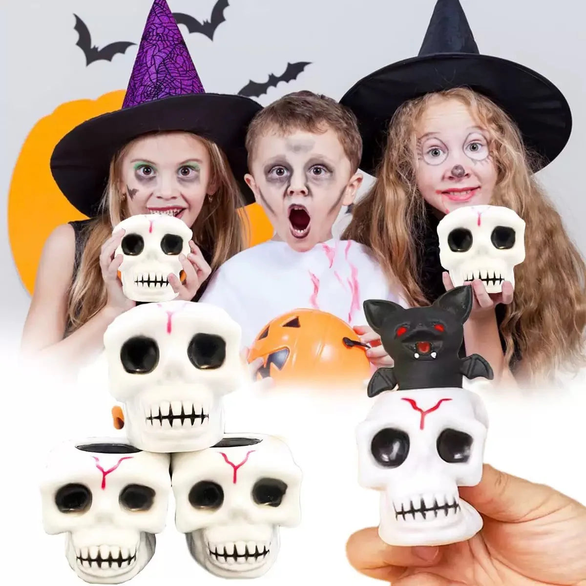 A group of people holding Halloween squeeze stress balls shaped like skulls and cats.