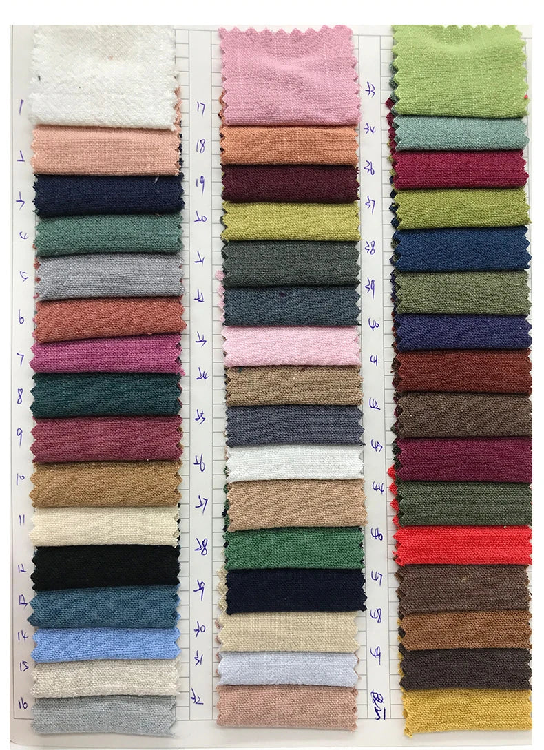 A collection of various colored linen napkins displayed in a vertical row.