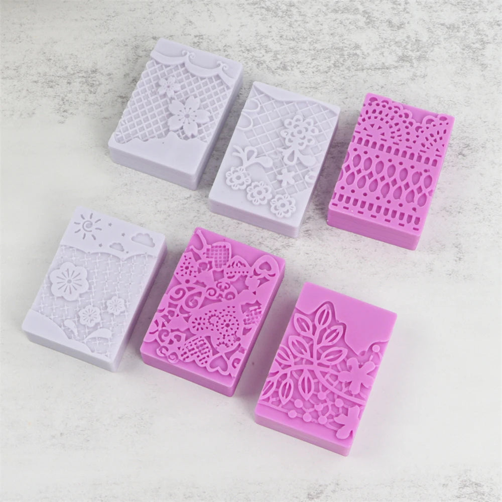 Six silicone soap molds in white and pink with intricate lace patterns for handmade soap and DIY crafts
