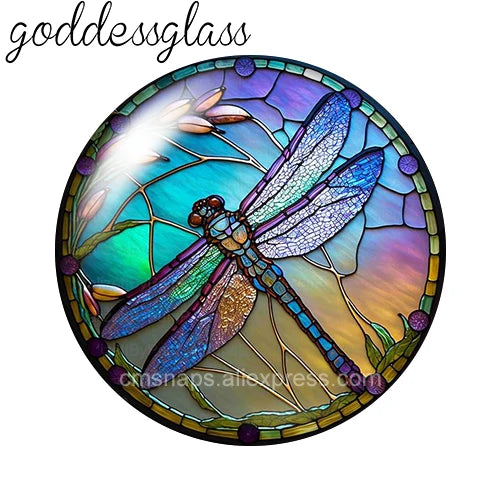 Round glass cabochons shaped like a dragonfly in iridescent blue and green colors.