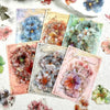 A collection of floral hot stamp stickers featuring various shades of blue, green, and pink flowers on white paper.