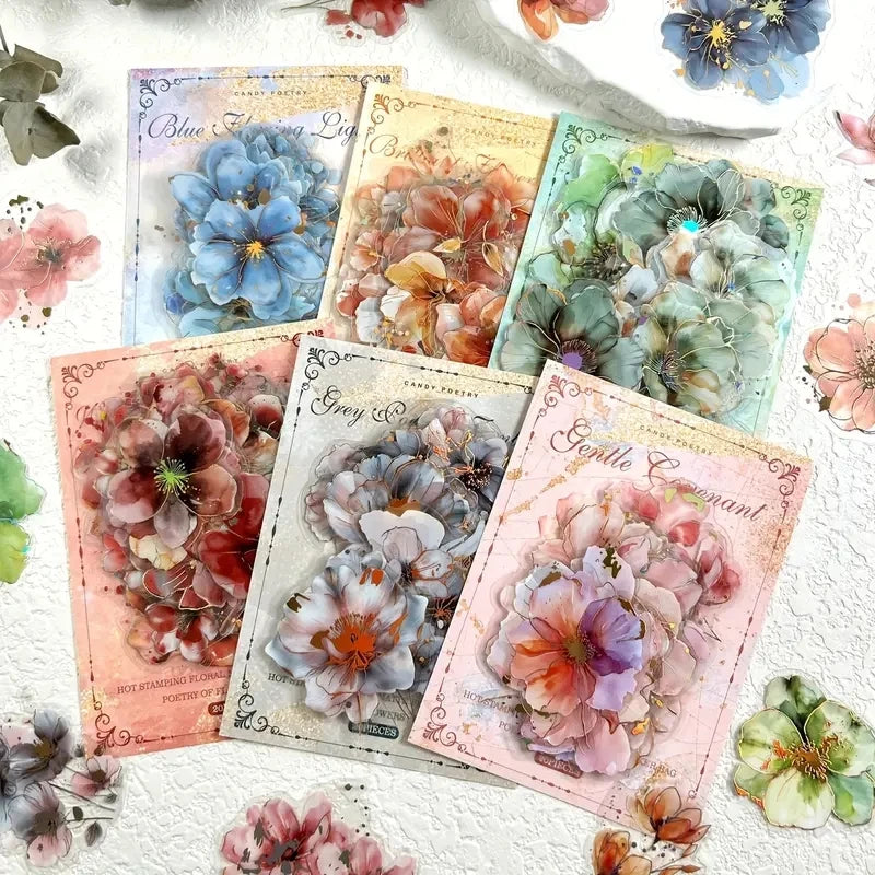 A collection of floral hot stamp stickers featuring various shades of blue, green, and pink flowers on white paper.
