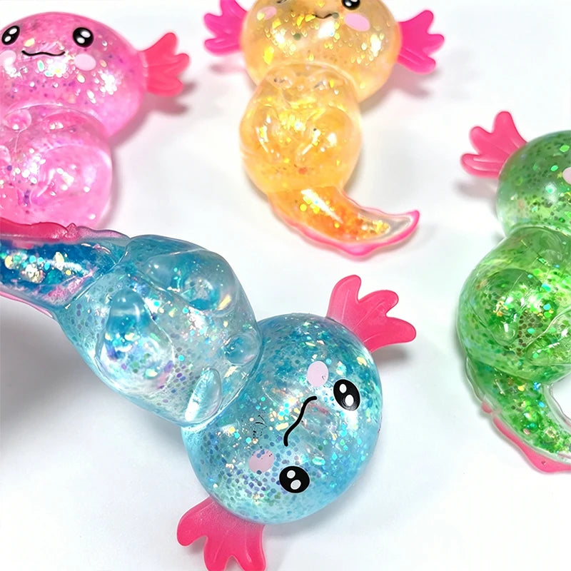 A collection of colorful glitter axolotl squishy stress relief toys in pink, yellow, and blue.