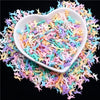 A heart-shaped dish filled with colorful polymer clay sprinkles for slime and craft decor