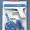 A white electric automatic water gun is displayed on a blue and white patterned surface with various components like a drum m