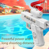 A white plank gun toy is shown aiming at a blue swimming pool with a red water slide in the background.
