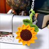 Handmade crochet sunflower charm attached to a silver car mirror.