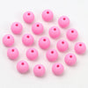 A collection of pink matte acrylic beads shaped like macarons for jewelry making