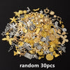 A pile of random mixed metal charms including stars, leaves, and various decorative elements for DIY jewelry making