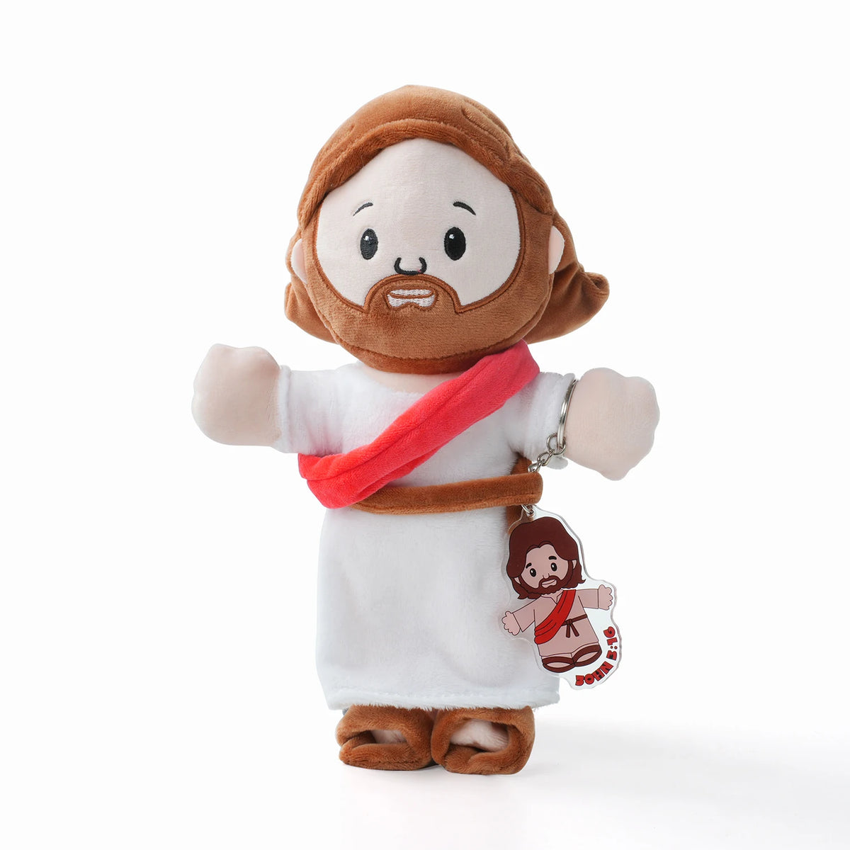 A plush toy of Jesus with a beard and brown hair wearing a white robe and a red sash.