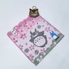 A pink and green embroidered patch featuring a cartoon cat, a white mouse, and a blue bird.