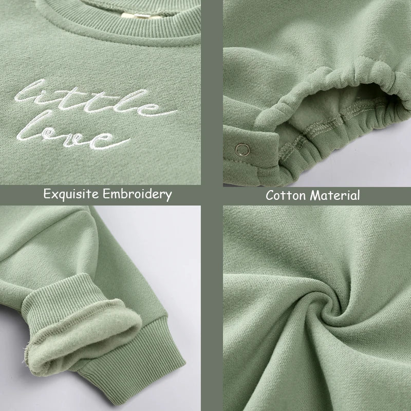 Close-up of a sage green embroidered cotton garment showing the phrase little love and fabric texture.
