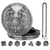 A silver Steampunk dragon pocket watch dice case with a central design and seven small dice.