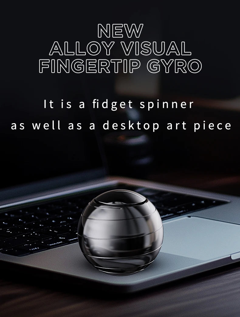 A silver metal fidget spinner resting on a laptop keyboard.