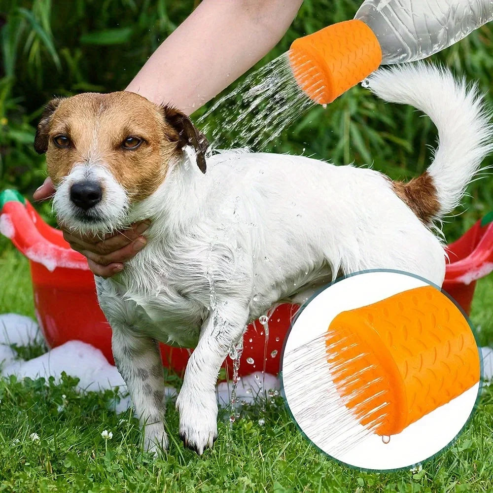 A dog is being washed with an orange silicone pet shower head outdoors.
