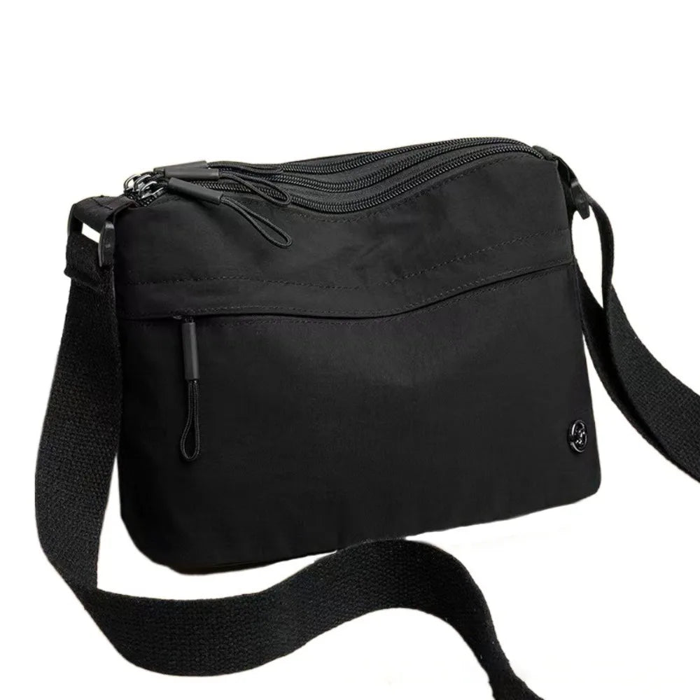 Black floral canvas tote bag with multiple pockets and a shoulder strap