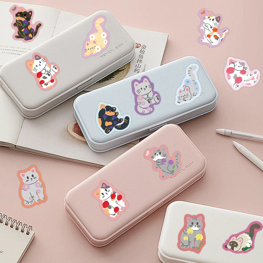 A collection of cute cartoon cat stickers in various colors and styles displayed on a pink background.