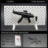 A black 1:6 scale military submachine gun model is displayed on a white pegboard with various small parts and a scale referen