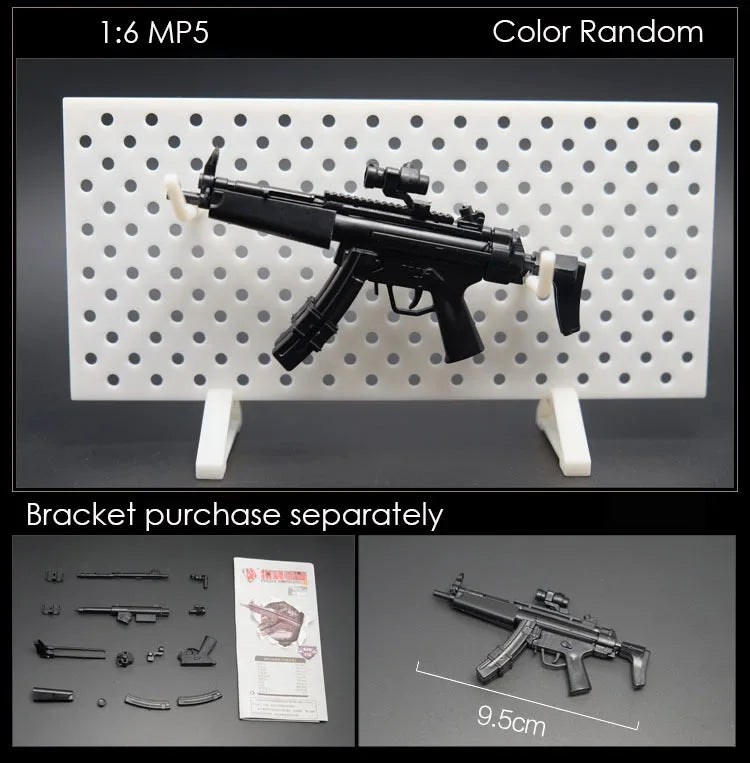 A black 1:6 scale military submachine gun model is displayed on a white pegboard with various small parts and a scale referen