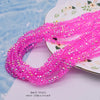 Pink faceted crystal rondelle beads for jewelry making strung on a white plate