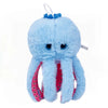 A light blue, fluffy shark plush toy with a small blue crown detail.