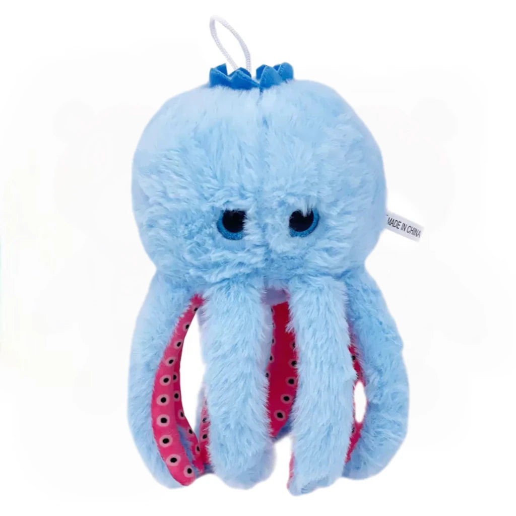 A light blue, fluffy shark plush toy with a small blue crown detail.