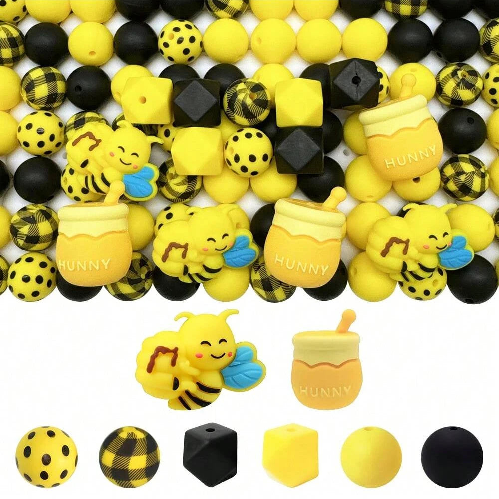 A collection of yellow and black silicone beads shaped like bees for DIY crafts.