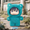 A plush collectible figure of Gojo Satoru wearing a teal hoodie with black hair, displayed outdoors.