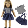 A doll wearing a navy blue skirt and a black and white striped top, with a separate navy blue fabric bag shown beside it.