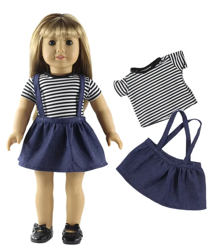 A doll wearing a navy blue skirt and a black and white striped top, with a separate navy blue fabric bag shown beside it.