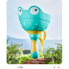 A cyan pull-string flying saucer launcher toy for kids is shown against a natural outdoor background.