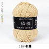 A ball of light beige milk cotton yarn labeled with Chinese characters and the size 18 knitting needle gauge.