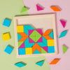A wooden geometric shape puzzle featuring colorful triangles and squares arranged in a frame on a pink background.