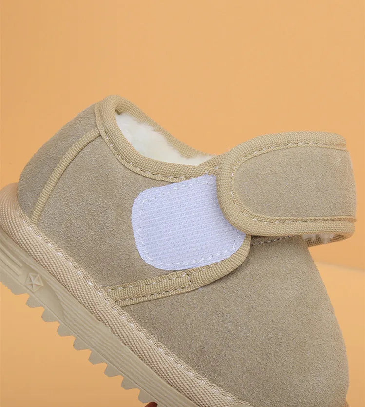 A tan leather winter boot for toddlers with a padded ankle and anti-slip rubber sole.