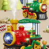A red and yellow electric steam train truck with lights and wheels on a track.