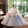 A white and light blue tulle princess dress displayed on a mannequin.