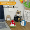 A collection of handcrafted crochet shark dolls and a laptop on a wooden desk.