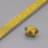 A gold glitter paper strip is shown alongside a folded origami star shape.