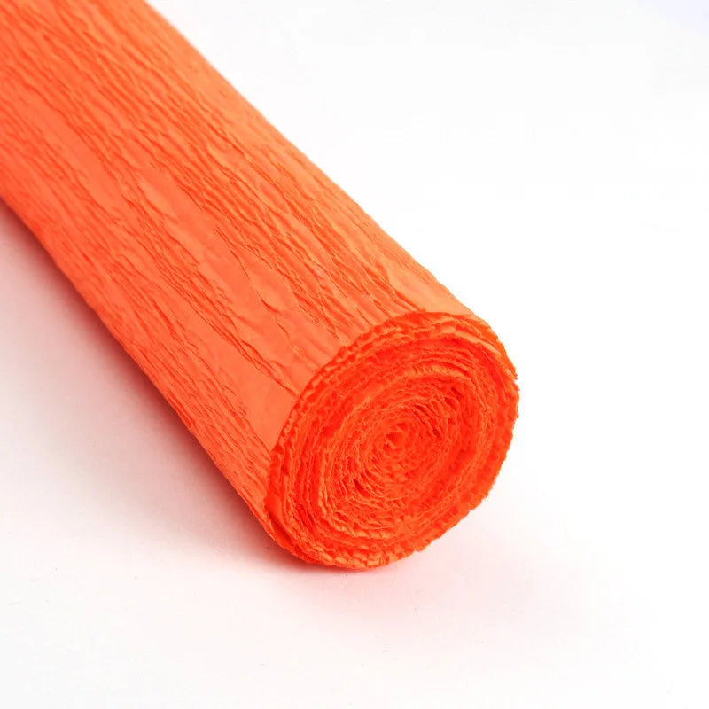 A roll of bright orange crepe paper for DIY crafts and gift wrapping.