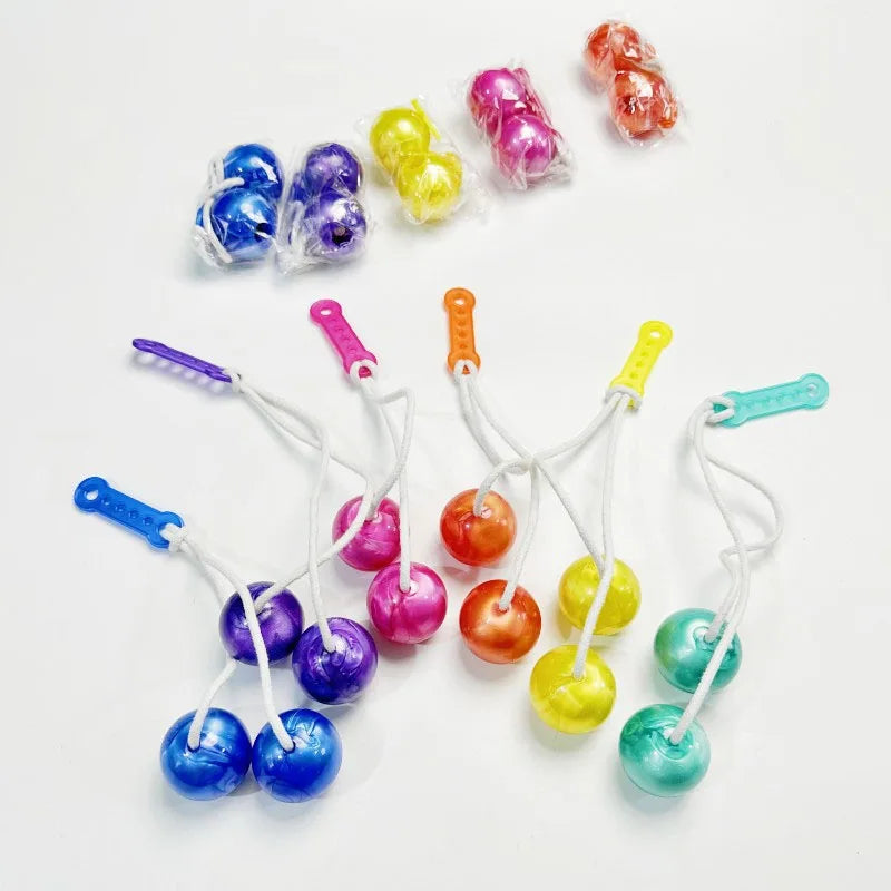 A collection of colorful click clack fidget balls on strings, including blue, purple, yellow, and orange.