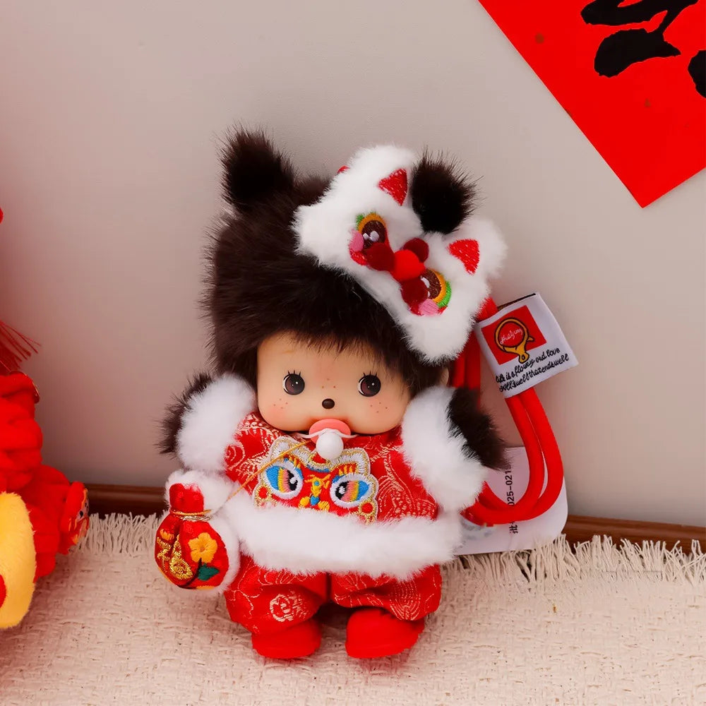A small brown Monchhichi plush toy with white fur and red clothing, displayed against a white background.