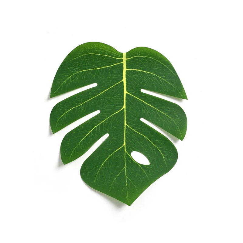 A vibrant green artificial tropical palm and monstera leaf with characteristic fenestrations.