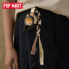 A blind box keychain featuring a Hirono Mist-Walker character attached to a dark denim garment.