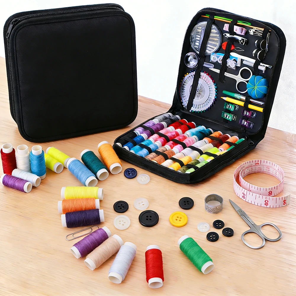 A complete sewing kit with various threads, needles, and tools is displayed alongside a black travel storage box.