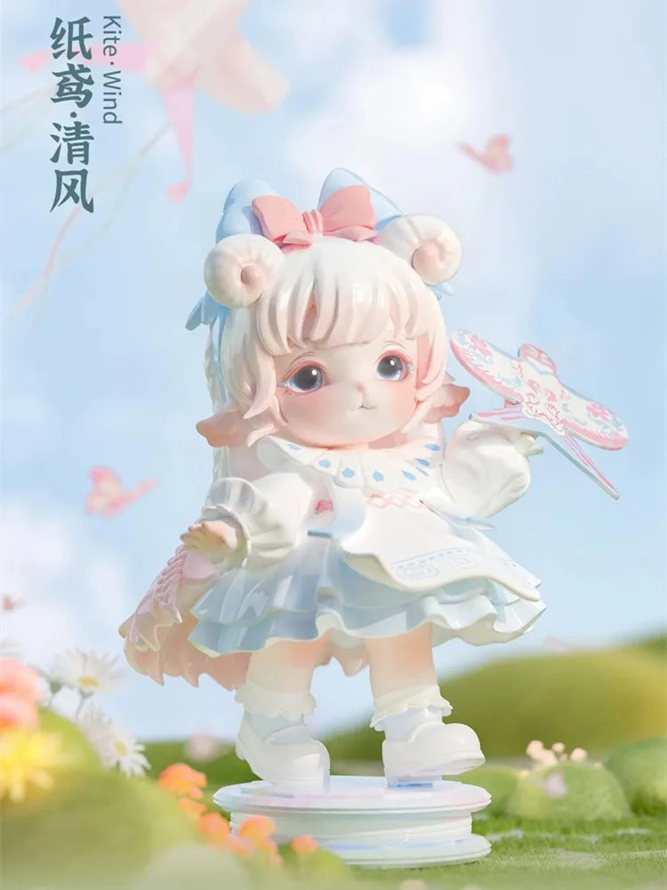 A cute figurine of a girl with pink hair and white dress, featuring light blue accents and a pink bow, standing in a grassy o