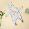 A white and gray chevron romper set for a baby doll, accompanied by a matching elephant-shaped accessory.