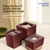A set of three dark brown wooden puzzle boxes containing wooden blocks for a 3D challenge.