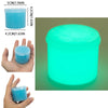 A small, translucent blue slime container with a glowing cyan light, shown next to a hand for scale.