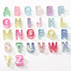 A collection of colorful acrylic alphabet beads in various shades and sizes for jewelry making