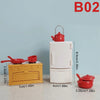 A white miniature dollhouse furniture set featuring a yellow oven and a red teapot on a light blue background.